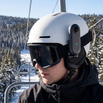Alpyn camera clipped to the side of a white ski helmet on a chairlift